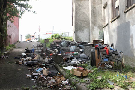 Trash often accumulates around the abandoned police station, empty since 1988.